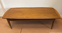 Front view of coffee table showing rectangular top and tapered legs