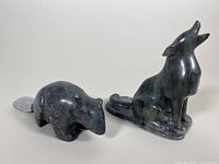 Wolf and beaver soapstone carvings side by side viewed from above and front