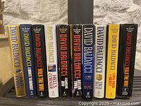 Books arranged in a row showing titles and author name on spine.