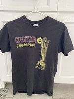 Front of a black Led Zeppelin 'Stairway to Heaven' women's small t-shirt showing band name, song title, and skeletal hand graphic.