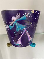 Front view showing purple background with blue fairy, white hair, colorful dots, and blue foot