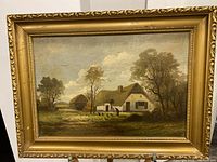 Frontal image of the framed vintage oil on board painting showing a rural scene with a cottage, trees, woman, and chickens.