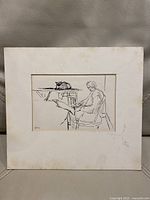 Vintage pen ink drawing showing a minimalist scene with a woman reading and a cat on the table.