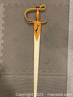 Full sword laid flat showing entire length and design
