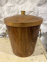 Photo of the teak ice bucket showing the fitted wooden lid with a brass knob and the brass ring handles on the sides.