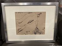 Silver IKEA frame with white matting contains an abstract vintage ink artwork on beige paper showing flowing organic forms with fine lines and dots.