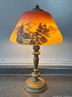 Full view of lamp on counter against gray wall.