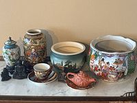 Full lot arrangement showing all decorative items including jars, vases, Buddha figurines, and cup and saucer.