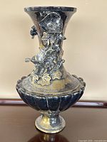 Full view of the large antique silver plated brass urn showing overall shape and floral embellishments