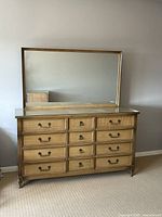 Front view of vintage Strathroy wooden vanity dresser with rattan inset drawer fronts and large detachable mirror on top