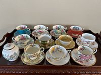 Full collection of 11 floral teacups and saucers plus Ansley Wild Tudor jar on serving tray