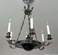 Full front view of six-light chandelier hanging from ceiling