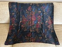 Full view of the scarf laid out flat showing floral pattern on black background.