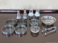 Full lot showing all items including salt and pepper shakers, coasters, condiment dish, bowl, and tongs