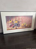 Full view of framed Rolie Polie Olie CG art print on floor, showing all characters dancing.