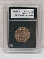 Front side of 1979-D Susan B. Anthony dollar coin in protective encapsulation with certification label visible.
