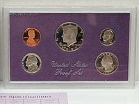 Full view of 1987 US proof set with 5 coins in plastic casing on purple card