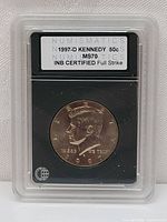 Encapsulated 1997-D Kennedy Half Dollar coin in plastic graded holder by INB with certification label.