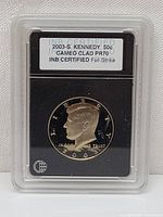 Front view of the 2003-S Kennedy Half Dollar PR70 Cameo Clad coin certified by INB in a plastic slab.