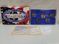 Complete lot showing the box, coin case with five 2005 Philadelphia Mint state quarters and Certificate of Authenticity in front.