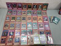 Overview of the variety of Yu-Gi-Oh! trading cards laid out, showing different monsters and some trap cards with varied artwork and colors.