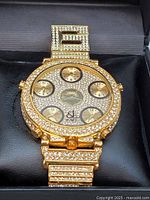 Front face showing pavé crystal dial with five time zone subdials and crystal-set bezel