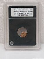 Front view of the Widow's Mite coin in a protective slab showing INB certification and date range 50 BC - 50 AD.