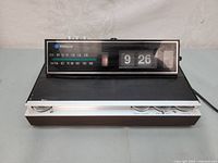 Front angle showing time and radio dial of Webcor CR1165 flip clock radio.