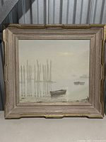 Full frontal view of the framed painting depicting boats on water with wooden posts in a misty background