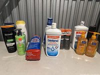 Full lineup of bathroom products including lotions, cleansers, shaving cream twin pack, steel wool, and more on a countertop in storage