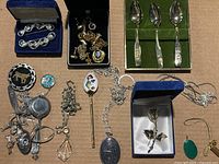 Overview of all loose and boxed jewelry items and souvenir spoons