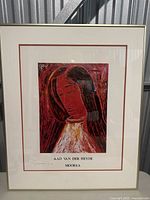 Framed artwork titled 'Moorea' depicting a woman in reds and whites, signed by Aad Van Der Heyde.