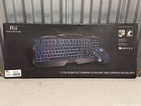 Boxed Rii brand keyboard and mouse set, showing product image and model details on packaging.