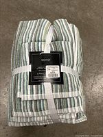 Photo of the Soho 6 piece towel set wrapped and tied with a label showing brand and price.