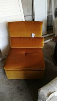 Front view of golden yellow velvet lounge chair