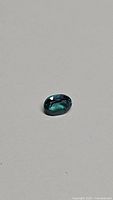 Oval cut bright deep lagoon blue green topaz gemstone with excellent clarity.