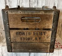 Front view of antique andler dairy wooden milk crate showing embossed brand name Lyons N.Y.