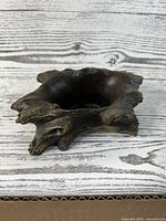 Side angled view of a handcrafted concrete succulent planter with wood-like texture