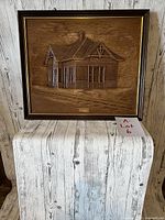 Full front image of the framed hand carved wooden picture showing the train station relief and frame.