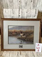 Full framed print showing two Canadian Geese by water, signed by artist, with wooden frame and double mat