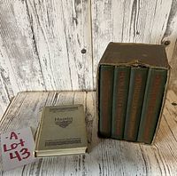 Photo showing the box set of four Shakespeare books next to the Hamlet book, with lot identifier card visible