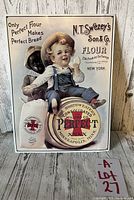 Front view of the vintage metal advertising sign featuring a boy sitting on flour sacks with text advertising Perfect Flour by N.T. Swezey's Son & Co.