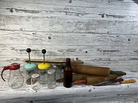 Full view of lot with vintage kitchen tools and accessories against white wooden background