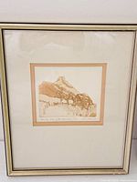 Framed etching showing mountain landscape with cabin and trees, titled and signed along lower margin.