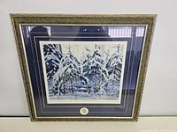 Framed print showing overall composition with snow-laden spruce trees and decorative frame.