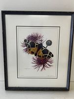Full view of the framed limited edition print featuring a yellow tiger moth resting on purple thistle flowers.