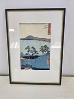 Full view of framed print leaning against wall