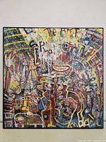 Front view of colorful mixed media panel in black frame