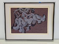 Framed print showing abstract figure composition in shades of grey on brown background.