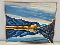 Full view of the oil on canvas painting showing mountainous landscape and water reflection in frame.